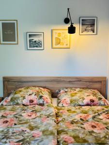 a bedroom with two beds and pictures on the wall at Siedlisko in Tuchów