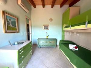 a bedroom with a bed and a desk in a room at Villa Flavia with pool and private parking in Costa Paradiso