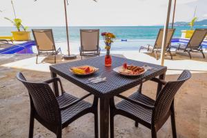 a black table with a plate of food on it at Hotel Bogavante in Barra de Navidad