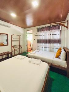 a room with two beds and a window at Sigiri Nisala Resort in Sigiriya +64 photos