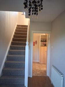 a staircase in a home with a chandelier at North Dublin 2-Bed House Sleeps 4 in Dublin +2 photos
