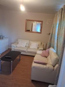 a living room with a couch and a table at North Dublin 2-Bed House Sleeps 4 in Dublin