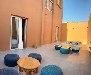 a room with blue chairs and a table andools at Imsouane Harmony in Imsouane