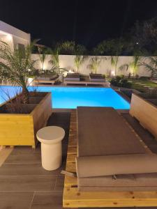 a swimming pool at night with a pool sidx sidx sidx at Villa Sivo in Kolymbia