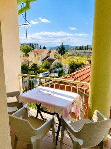 a table and chairs on a balcony with a view at Villa Jovan Gevgelija in Gevgelija