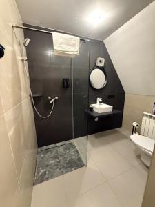 a bathroom with a shower and a sink at Pelican in Zagrody