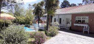 a house with a swimming pool and a patio at Casa La Bendición in Mar del Plata