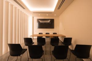 a meeting room with a table and chairs at PHEIA, Vriniotis Resorts in Katakolo