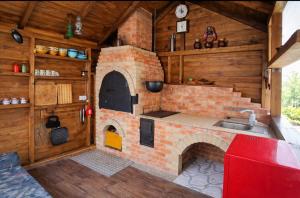 a kitchen with a brick oven in a house at Casa Mia in Câmpulung Moldovenesc
