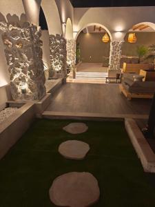 a lobby with a green carpet with rocks on it at Villa Sivo in Kolymbia +4 photos