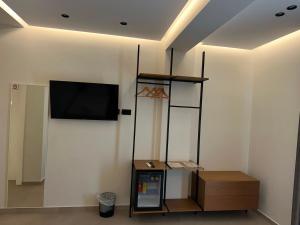 a room with a flat screen tv on a wall at Hotel Kloi - Rooms & Jacuzzi Vlore in Vlorë