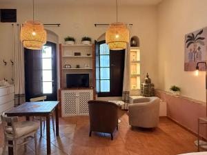 a living room with a table and chairs at Darcilla Guest House in Tarifa