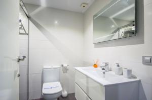 a white bathroom with a toilet and a sink at Apartamento rural Castillo de Yeste 2 pax Especial Parejas in Yeste +27 photos