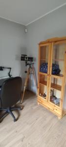a room with a desk and a camera and a chair at Dom przy lesie in Stare Juchy