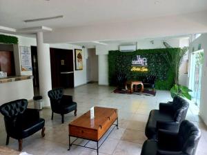 a lobby with chairs and a table in a room at VILLA COSTERA HOTEL BOUTIQUE in Acapulco