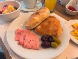 a plate of food with bread and fruit on a table at Hotel La Posada de los Volcanes - ALTARA in Arequipa