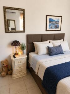 a bedroom with two beds and a teddy bear at Mijas Villa Doña Pilar Pool & Jacuzzi in Mijas