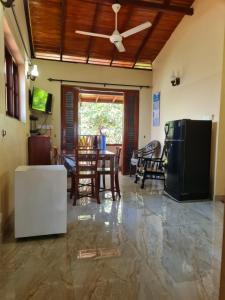 a living room with a ceiling fan and a table at Ama HomeStay Guest Colombo in Rajagiriya