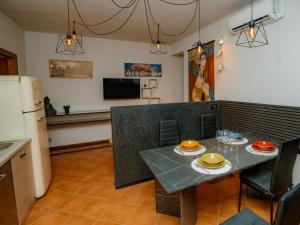 a kitchen and dining room with a table and a refrigerator at LA CORTE CHARME Diaz in Ravenna