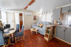 a kitchen and a living room with a couch and a table at Villa Thiago in Cádiz