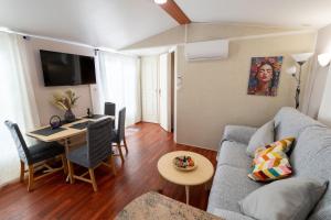 a living room with a couch and a table at Villa Thiago in Cádiz