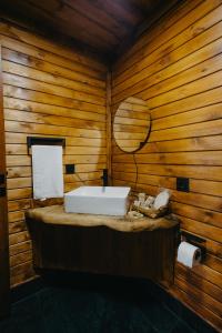 a bathroom with a white sink in a wooden wall at Indra Village Hotel in Pazar +68 photos