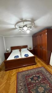 a bedroom with a large bed and a rug at House Pelcic Kostrena in Kostrena