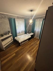a small room with a bed and a table at Apartamenty Trzcińsko 47 in Janowice Wielkie