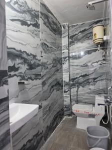 a bathroom with a sink and a toilet at Saira Mahal HOTEL in Ajmer +10 photos