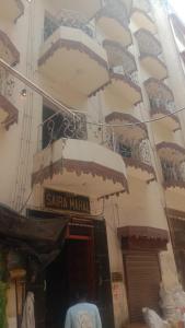 a snow covered building with a santa martinian sign on it at Saira Mahal HOTEL in Ajmer