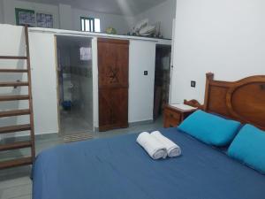 a bedroom with a blue bed with two towels on it at Casa Tanger in Tangier