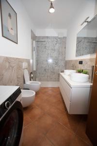 a bathroom with two sinks and two toilets at LA CORTE CHARME Diaz in Ravenna +33 photos
