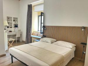 a bedroom with a bed and a desk in it at B&B Chiostro San Marco in Tarquinia