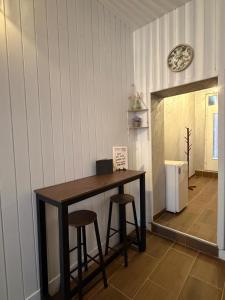 a table in a room with two stools and a mirror at Baja's Garden Apartman in Bajina Bašta +22 photos