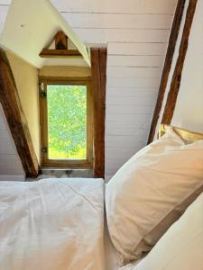 a bedroom with a bed and a window at Dreamy Perche landscape in Bivilliers