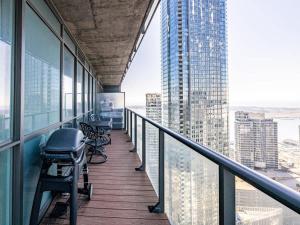 a balcony with chairs and a view of a city at Pristine Modern 2BR Condo Private BBQ and Balcony in Toronto +42 photos