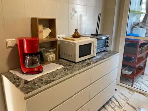 a kitchen with a microwave and a blender on a counter at Sable d or saidia in Saïdia