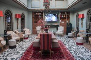 a large room with a table and chairs and a tv at Esperia Boutique Hotel in Agrinio