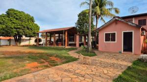 a cat standing in front of a house at Pousada Villa Cerrado in Caldas Novas