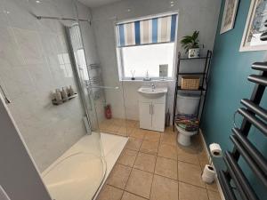 a bathroom with a shower and a sink at Cerrig in Llangollen +15 photos