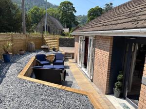 a patio with two chairs and a table at Cerrig in Llangollen