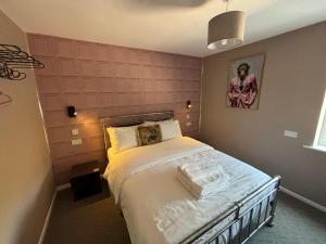 a bedroom with a dog laying on a bed at Cerrig in Llangollen