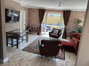 a living room with a couch and a table at Cerrig in Llangollen