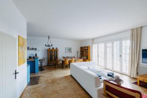 a living room with a white couch and a table at Villa Vista Pannonia in Donnerskirchen
