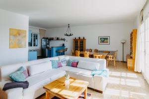 a living room with a white couch and a table at Villa Vista Pannonia in Donnerskirchen