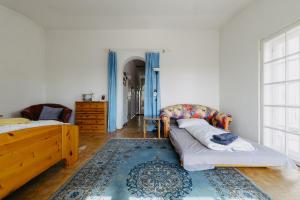 a living room with a bed and a couch at Villa Vista Pannonia in Donnerskirchen