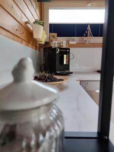 a kitchen with a black microwave on a counter at Domki Sielankowo in Odargowo +28 photos