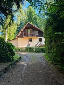 a house with a pathway leading to it at Na samotě u lesa in Libňatov