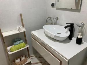 a bathroom with a white sink on a counter at Sable d or saidia in Saïdia +12 photos