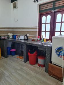 a kitchen with a counter with pots and pans at Ama HomeStay Guest Colombo in Rajagiriya +21 photos